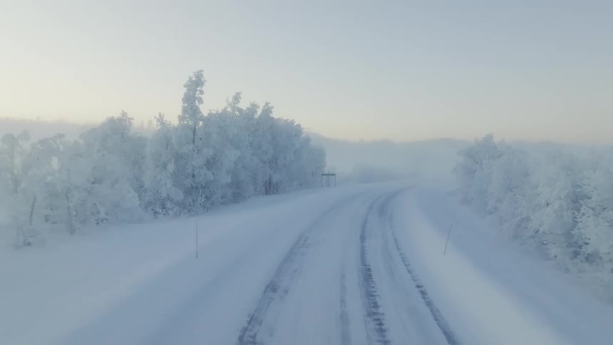 Driving across a storm on a snow covered road