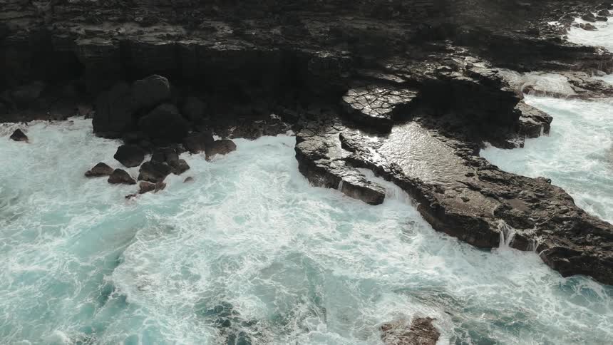 Waves are crashing against the shore