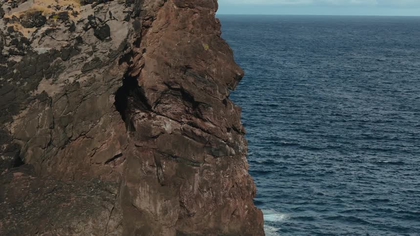 Landscape of the rocky coast on the edge of a blue sea