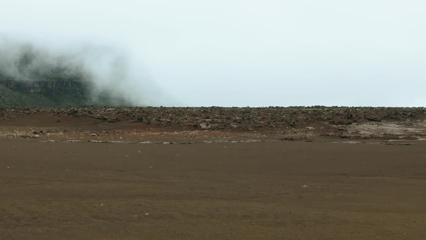 Panorama of the rocky coast with clay on a foggy day