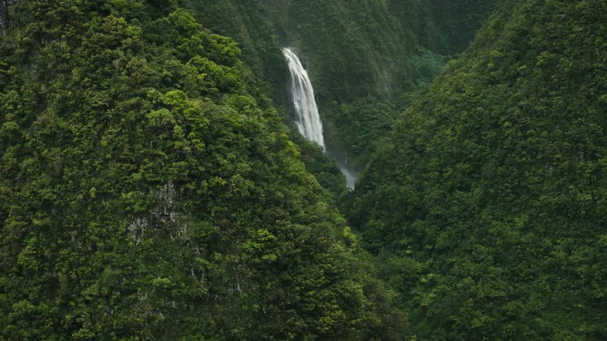 Aerial landscape of wooded mountains with a waterfall
