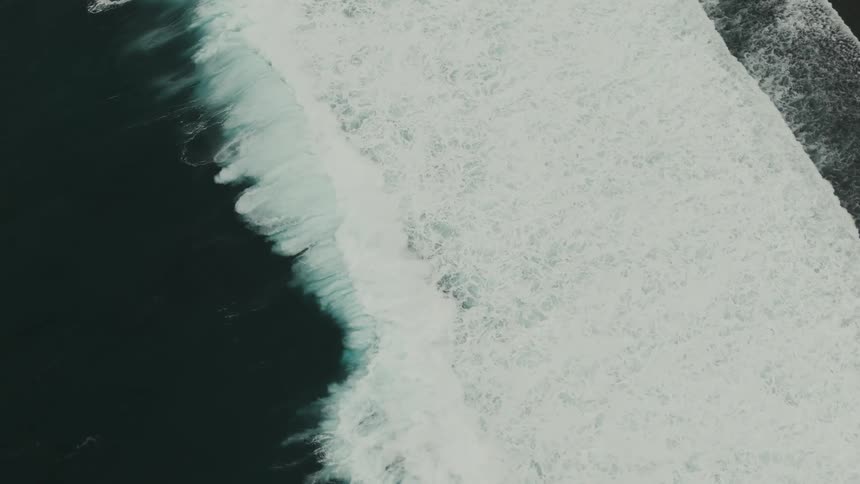 An aerial footage of sea waves in the beach