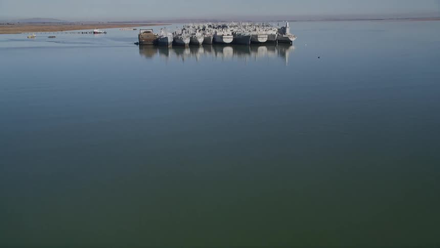 A navy shipyard with a diverse array of military vessels