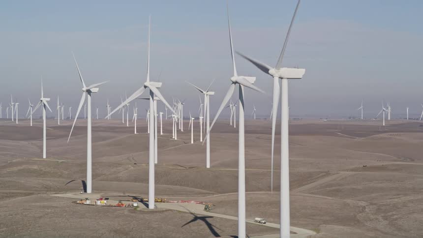 An aerial view of a wind turbine farm generating power