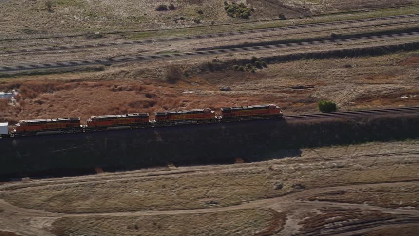 Aerial panorama of a moving freight train during the day