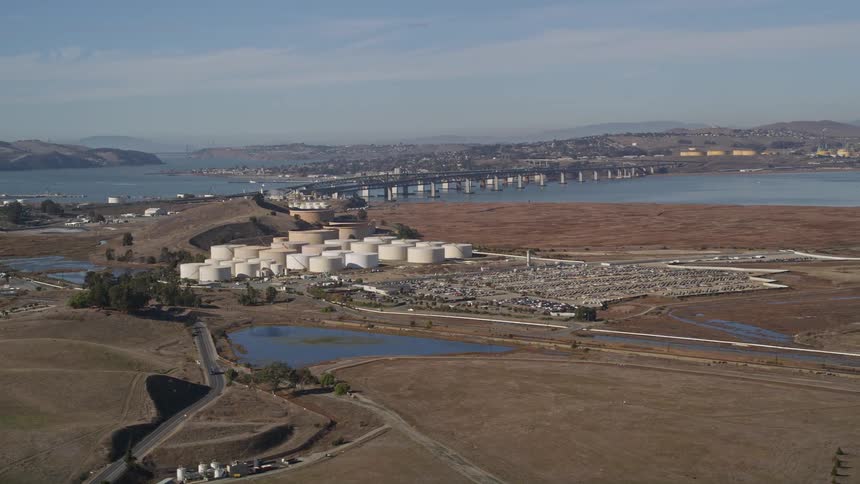 Aerial view of an oil refinery next to a lake a bridge connecting the two halves
