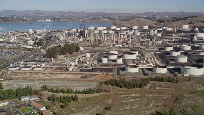 A large factory is by the shore