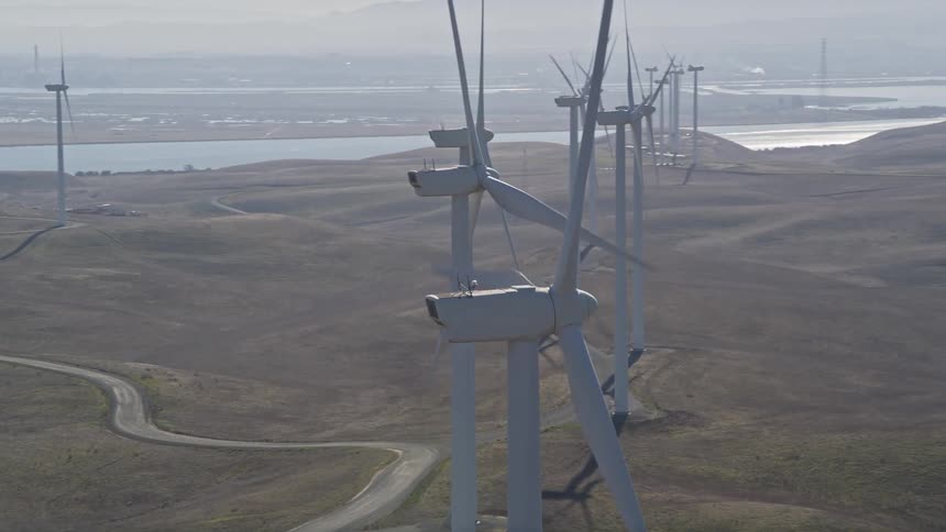 Rows of windmills slowly turn
