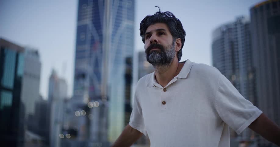 Portrait of a man observing the view of skyscrapers and buildings in a metropolis