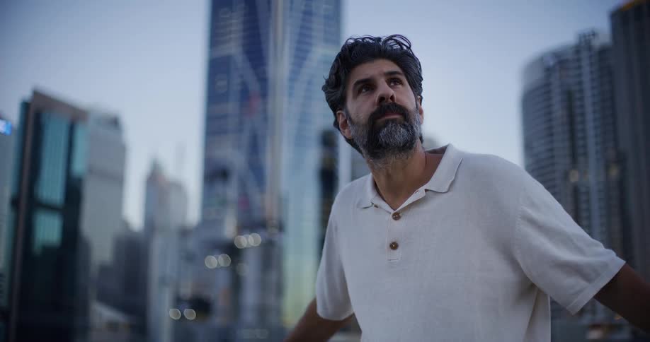 A man looks around at a big city