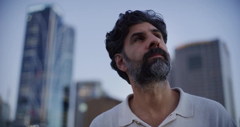 A man looks around at a city downtown