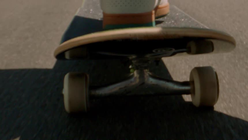 A person rides a skateboard in a street