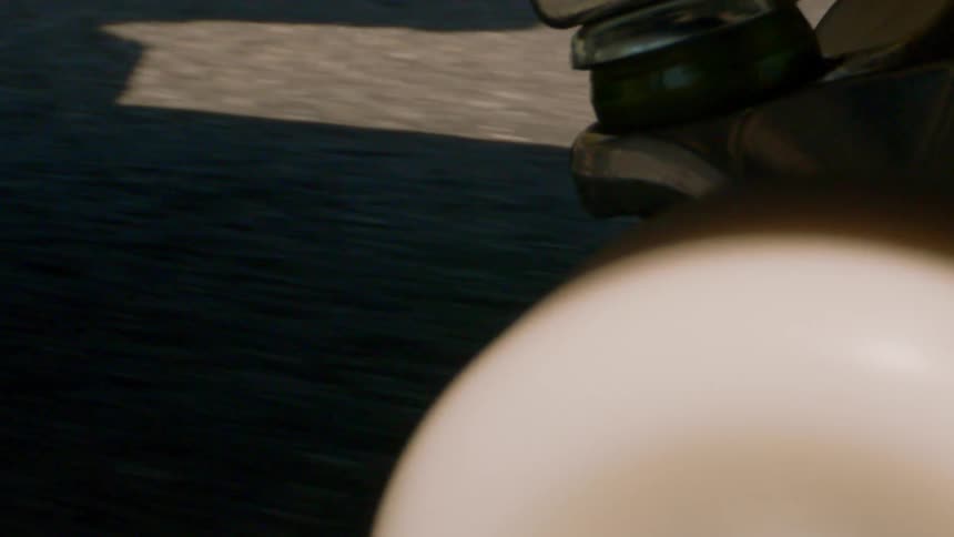 White wheels of a skateboard moving on the asphalt during the day