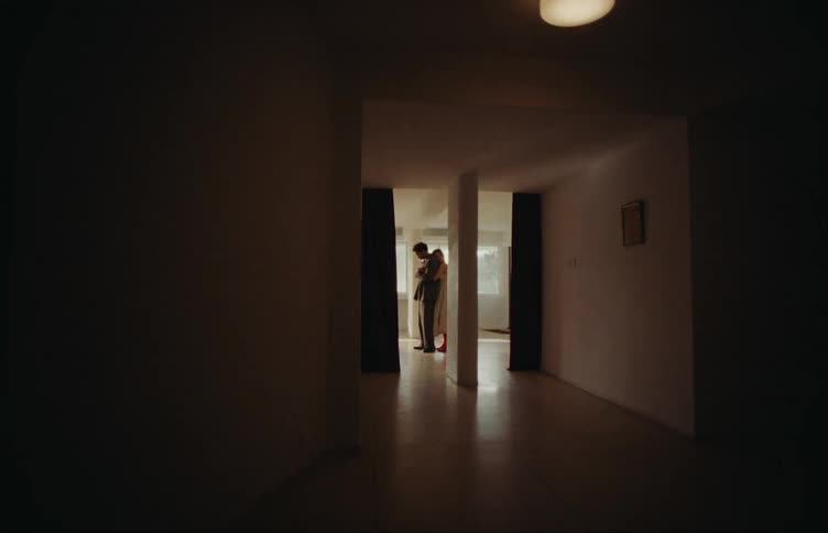 Woman hugging her boyfriend from behind romantically while indoors