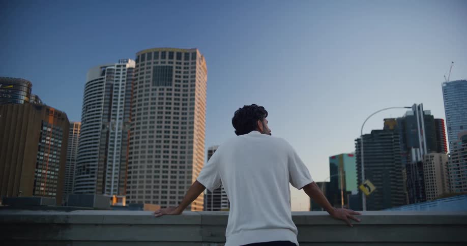 Man on his back enjoying the panoramic view of skyscrapers in modern buildings in a metropolis