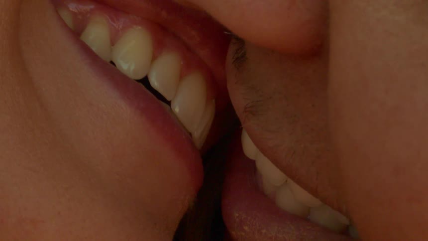 Close up of the lips of a couple kissing