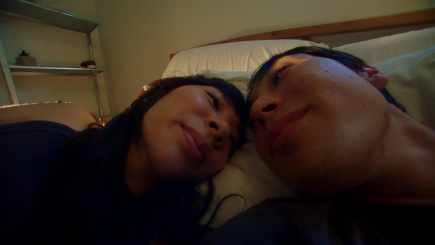 Close up of a young couple kissing in the bedroom