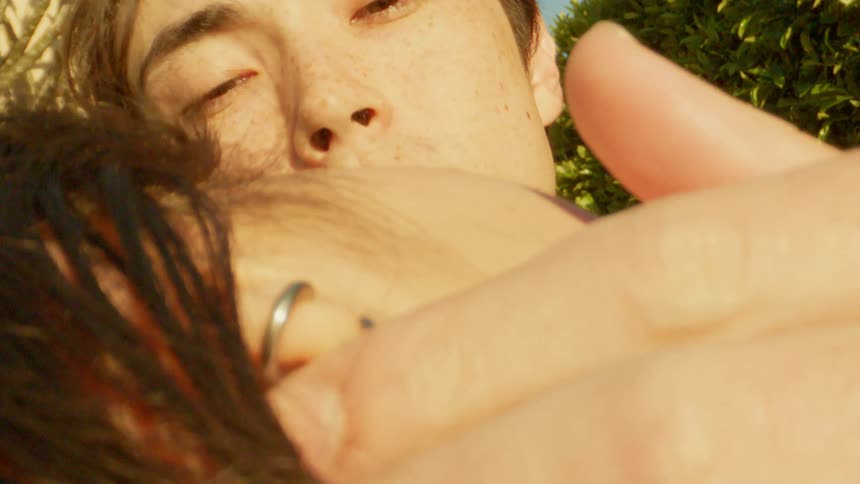 Portrait of a man caressing his girlfriends face while they are in an openair environment