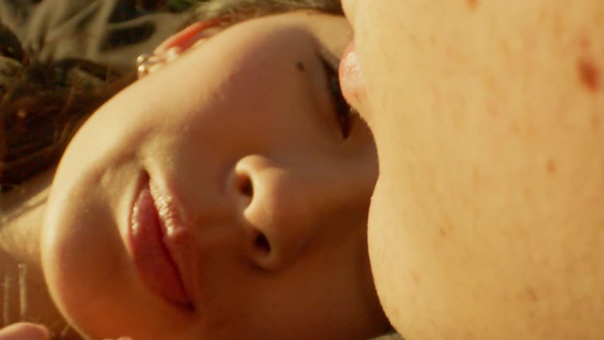 Close up of the faces of a young couple in sunlight