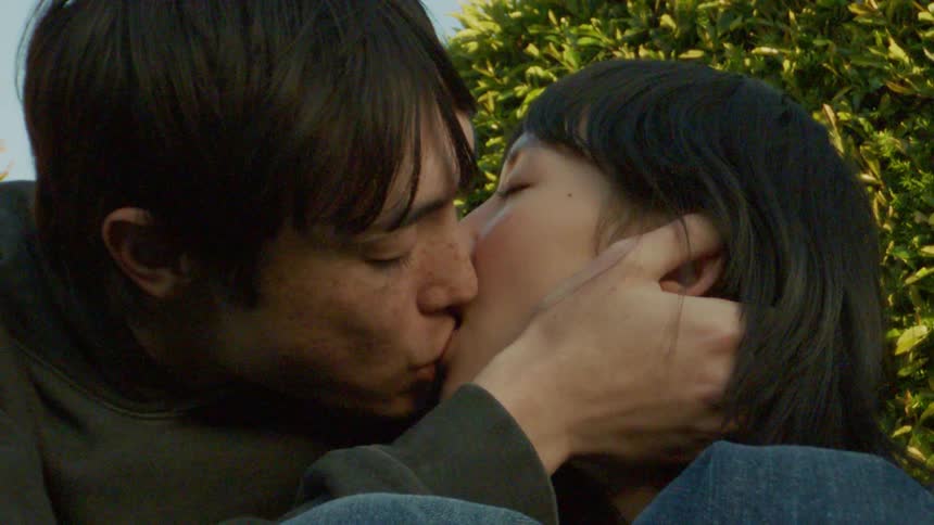 A man and woman are kissing
