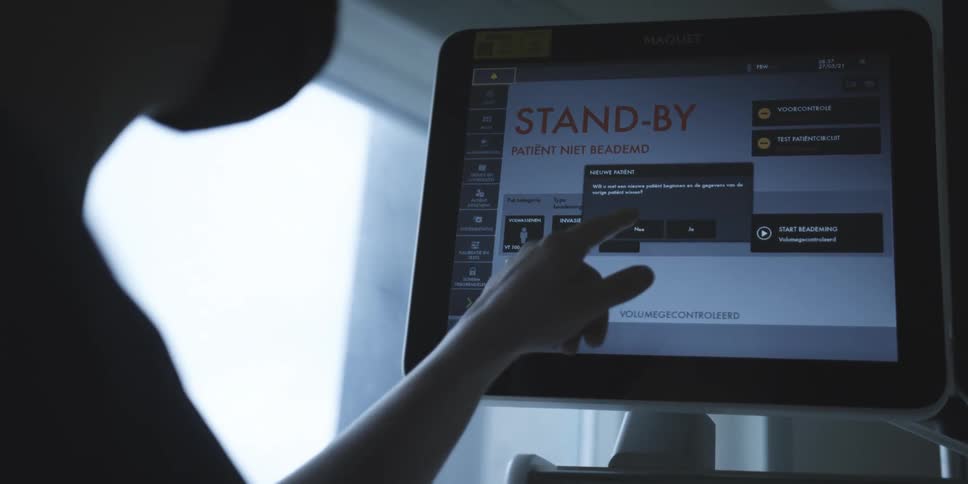 Silhouette of a female hand typing on a touchscreen