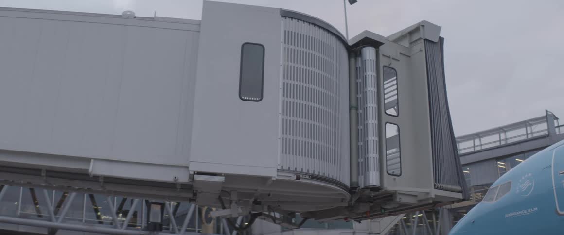 A jet bridge retracting from an airplane at an airport terminal
