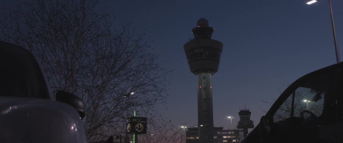 View of parked cars and modern towers in a metropolis at night