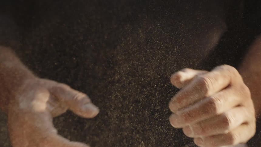 Close up of a person clapping his hands covered in flour
