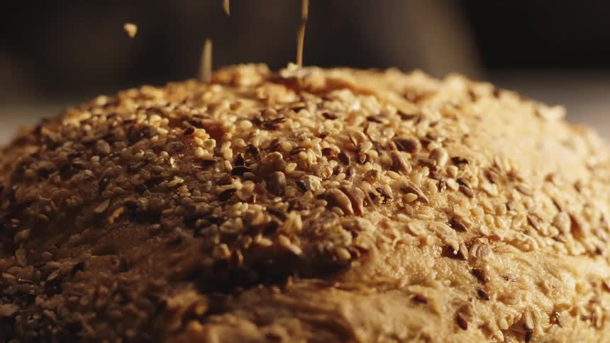 Grains being poured on top of a puff pastry
