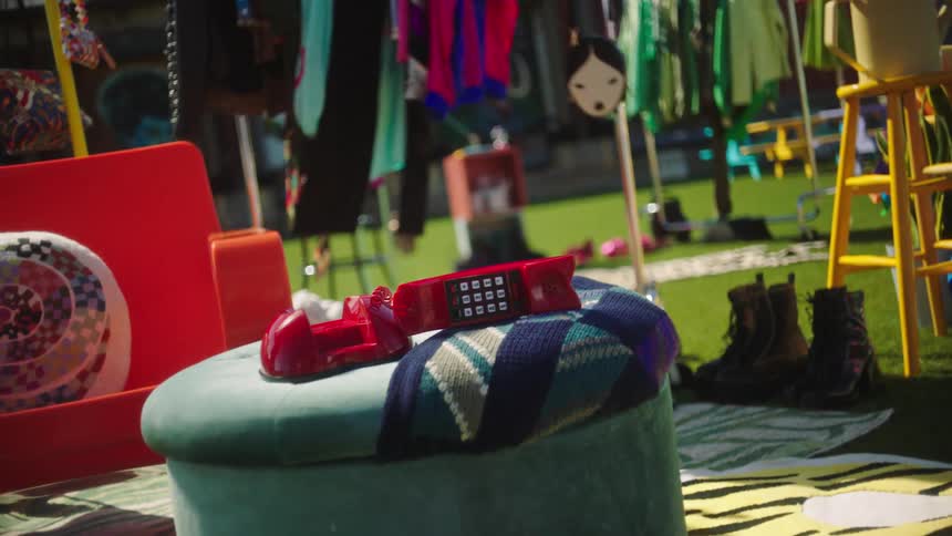 An old phone sits on a footstool