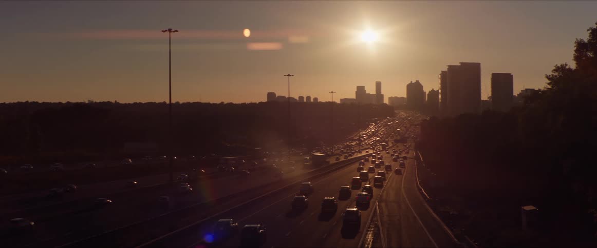 A busy highway heading toward a large city