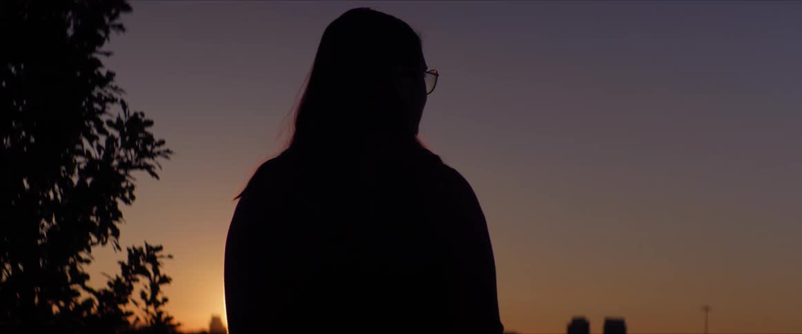 Silhouette of woman against a sunset sky