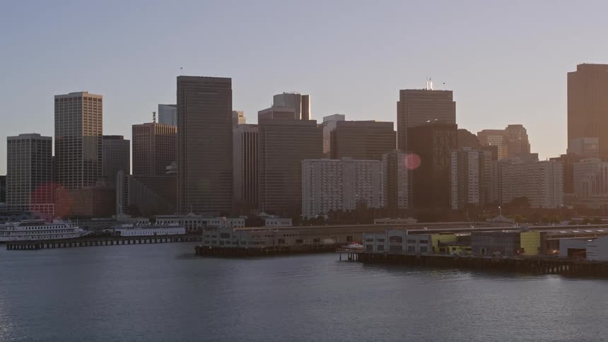 Boats are docked in the coast of the city