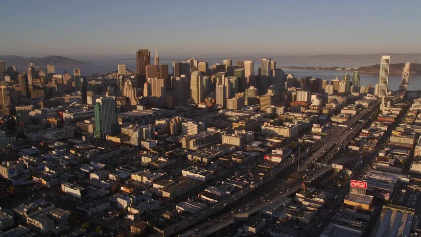 Traffic moves through a coastal downtown city