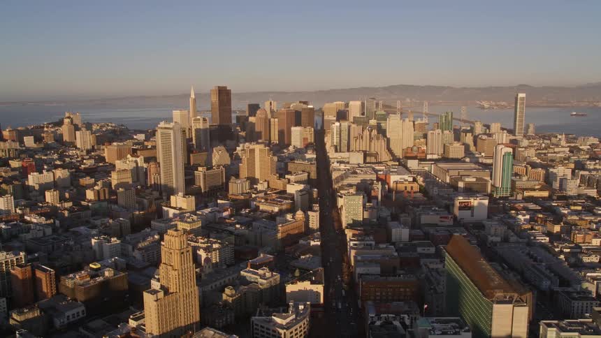 Panorama from above of a metropolis with large buildings by the sea in a morning sun