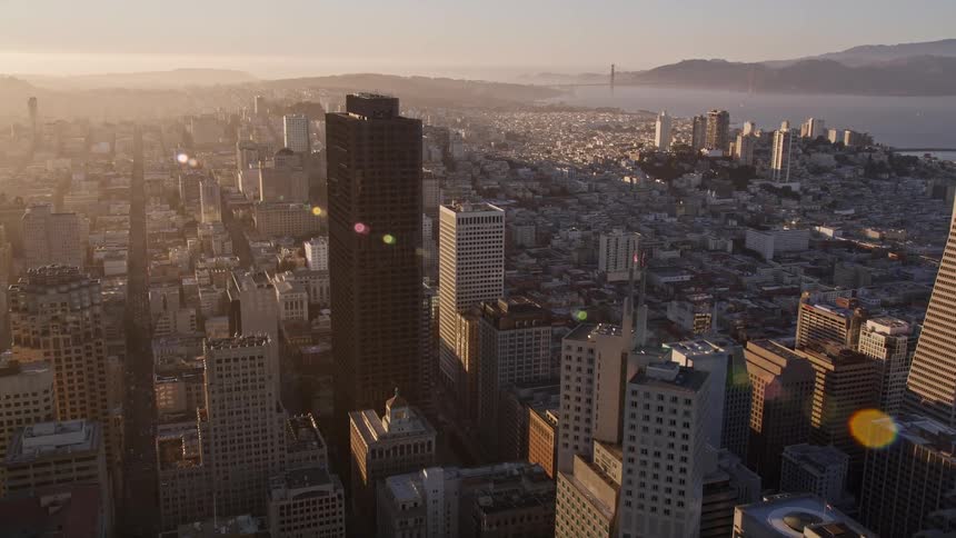 The sun is rising on the large city
