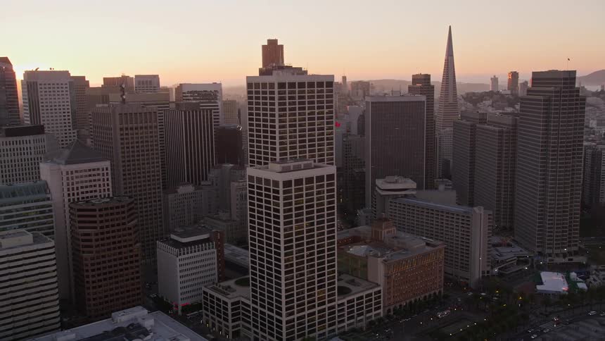 A city center with several tall commercial buildings on a day with strong sunlight