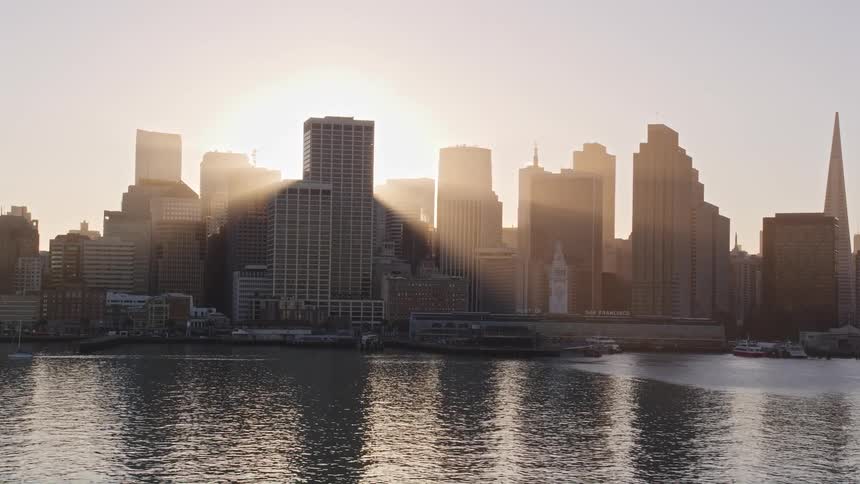 Aerial view of the sun setting behind the skyline of san francisco