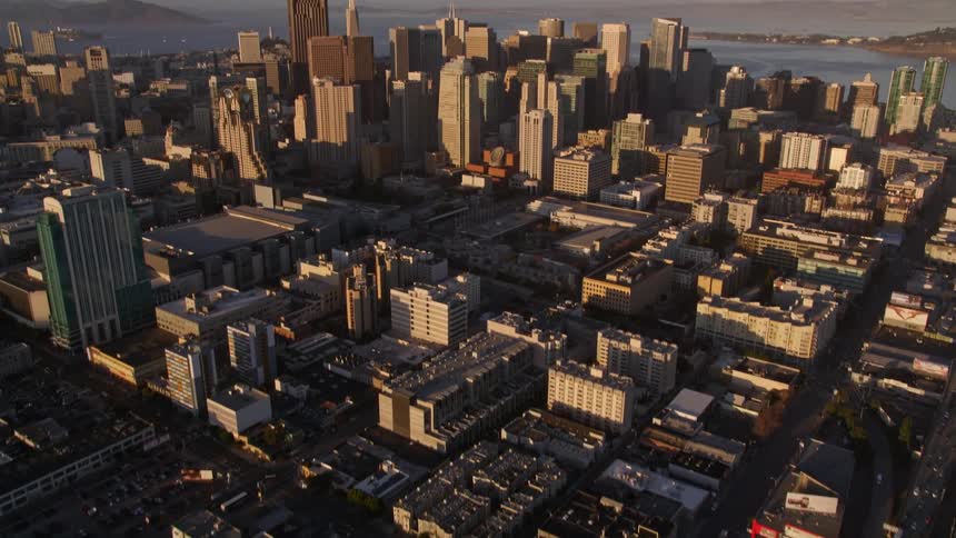 An aerial view of a huge city with a very busy street of cars and a center with many large buildings