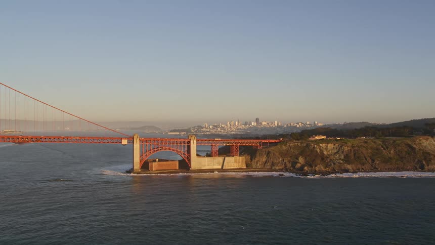 Golden bridge connecting mountains and a metropolis on the horizon
