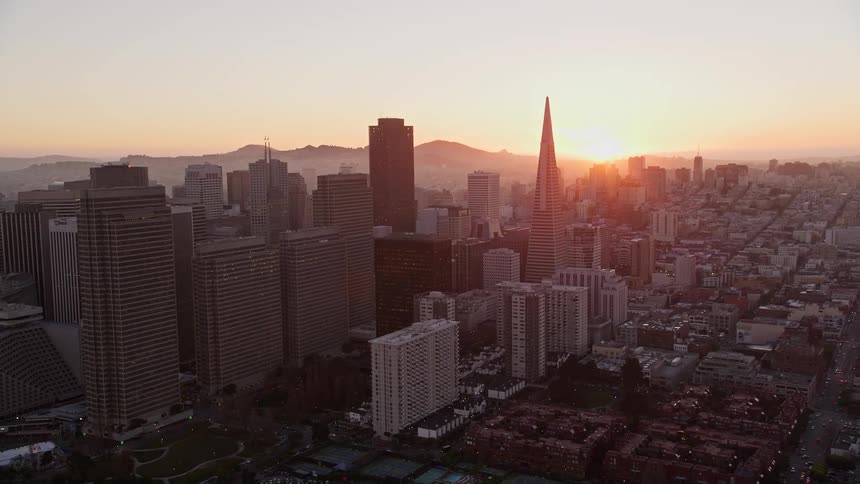 The sun is rising on the city