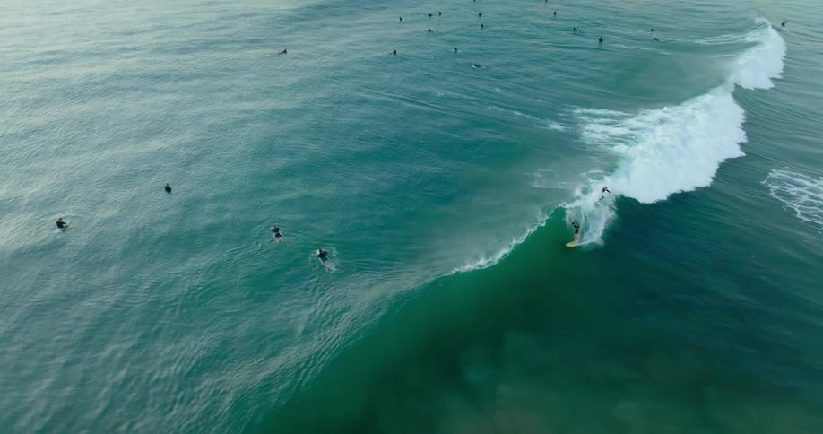 Aerial view of surfers riding ocean waves