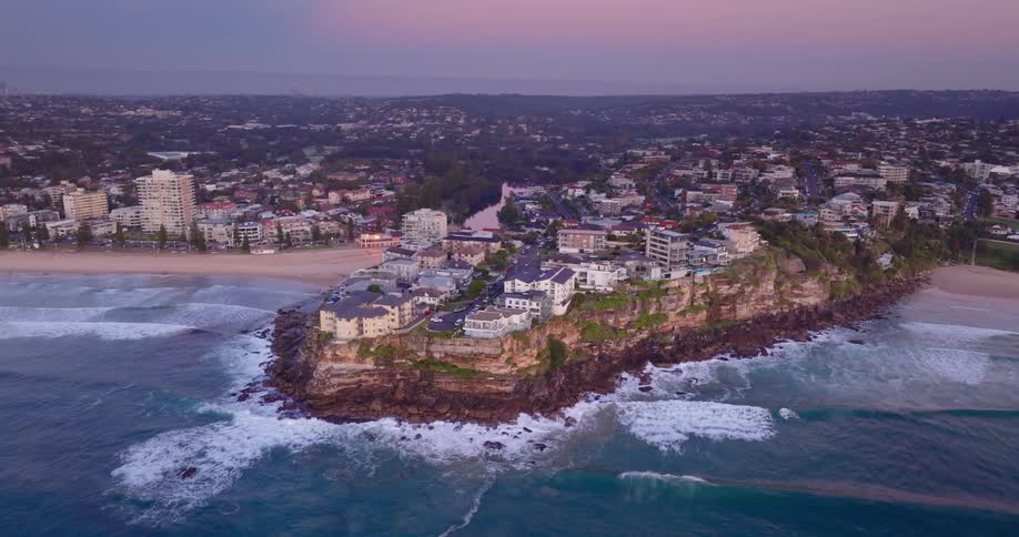 Panorama of the sea arriving from the coast with hotel and urban areas on a morning with a purple sky