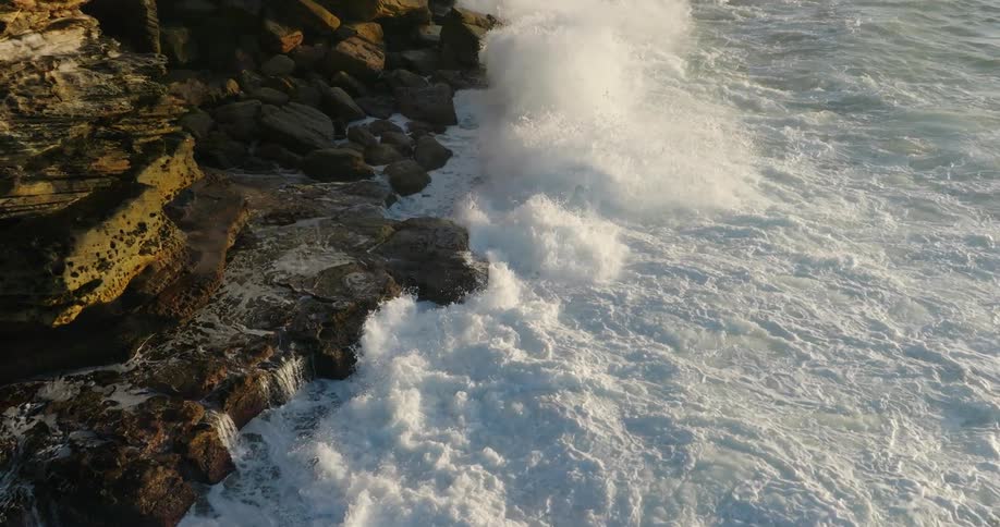 Big waves smash into a rocky coast
