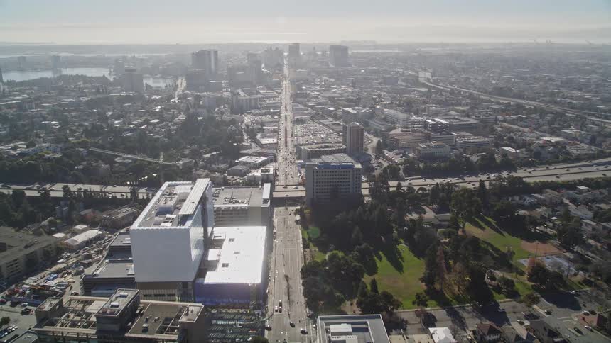 A major road cuts through a dense city