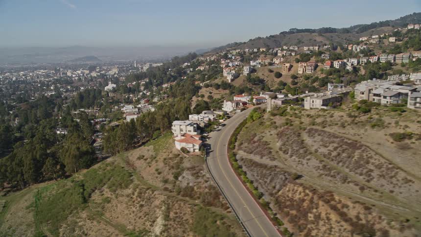 Large homes and buildings in a suburb on the side of a mountain