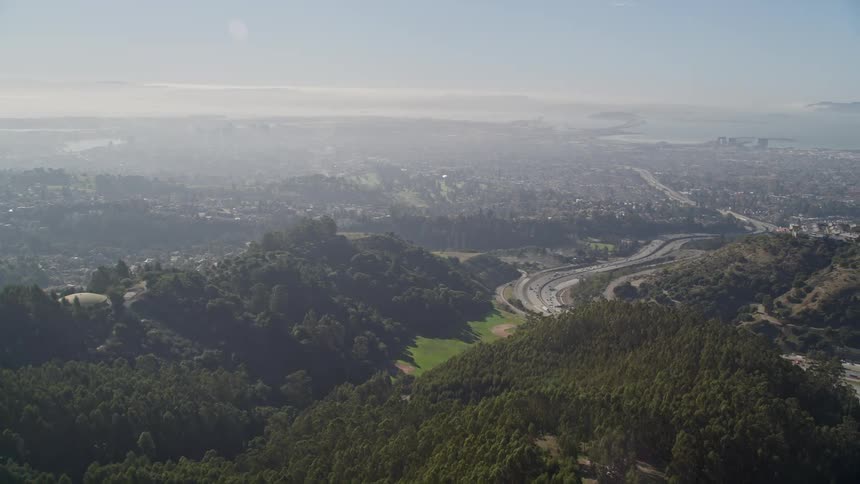 A suburban area near a highway coming out of a coastal city