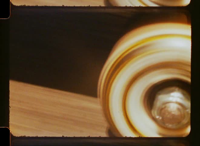 Extreme closeup on the wheel of a skateboard moving across the asphalt