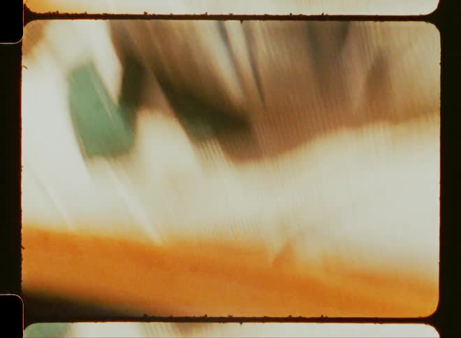 Extreme closeup of a skateboard moving across the asphalt