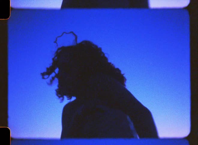 A woman is dancing in the dark